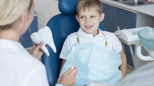 smiling little boy in dental chair