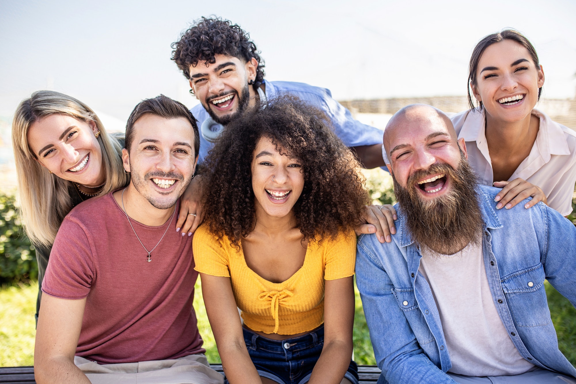 Multiracial group of young people smiling at camera