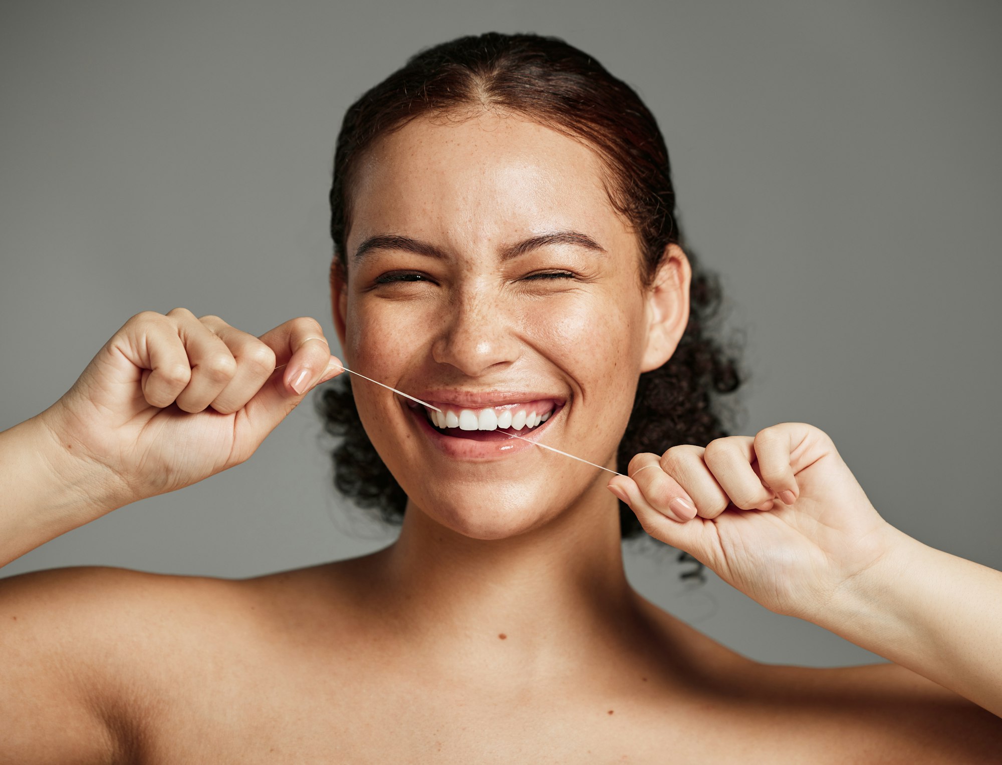 Dental floss, flossing teeth and woman with a smile for oral hygiene, health and wellness on studio