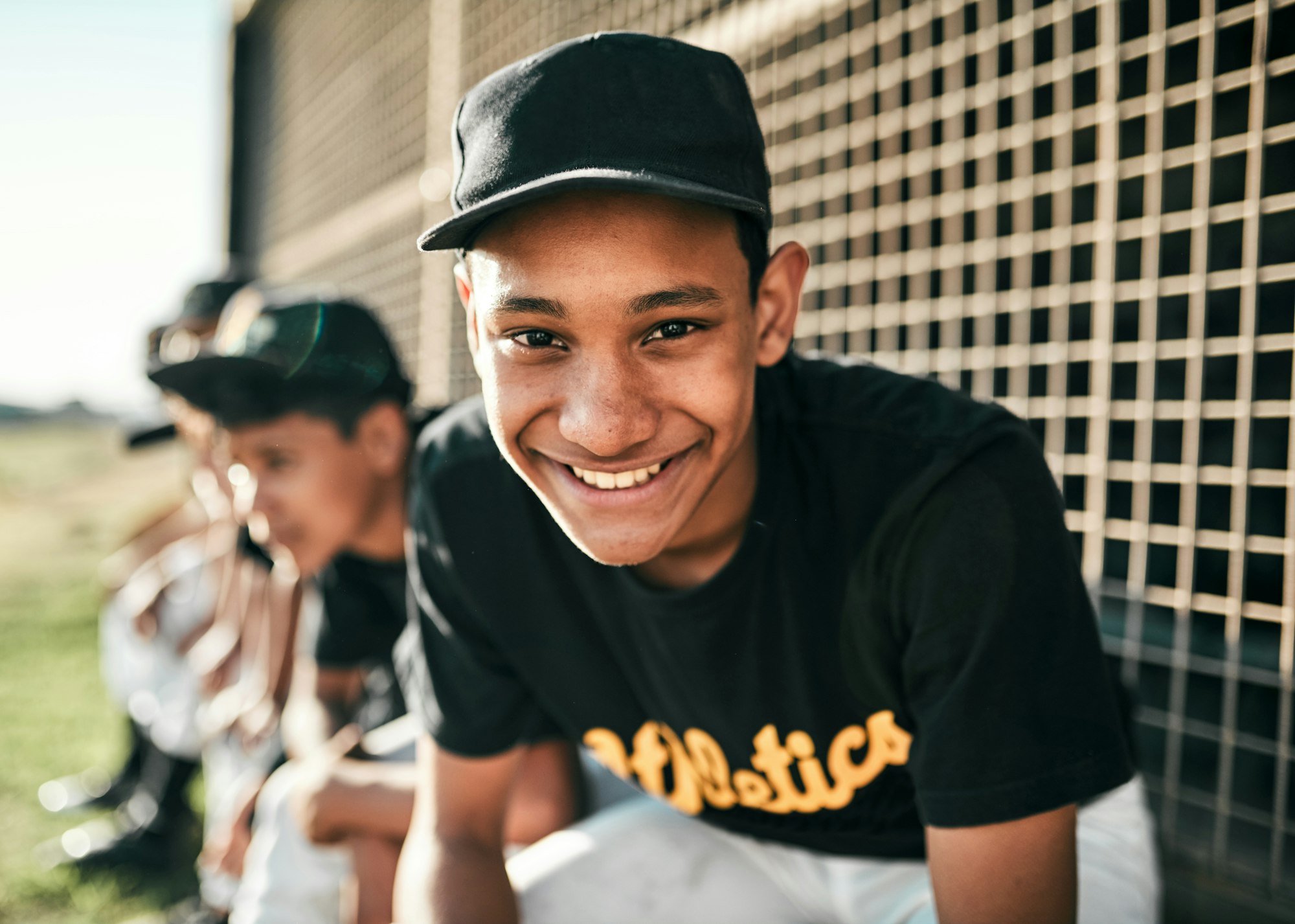 I play for the fun of it. Portrait of a young baseball player sitting on a baseball field.