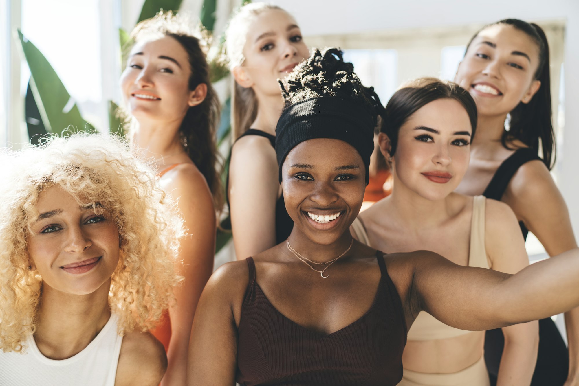 Multiethnic sportswomen smiling while taking selfie