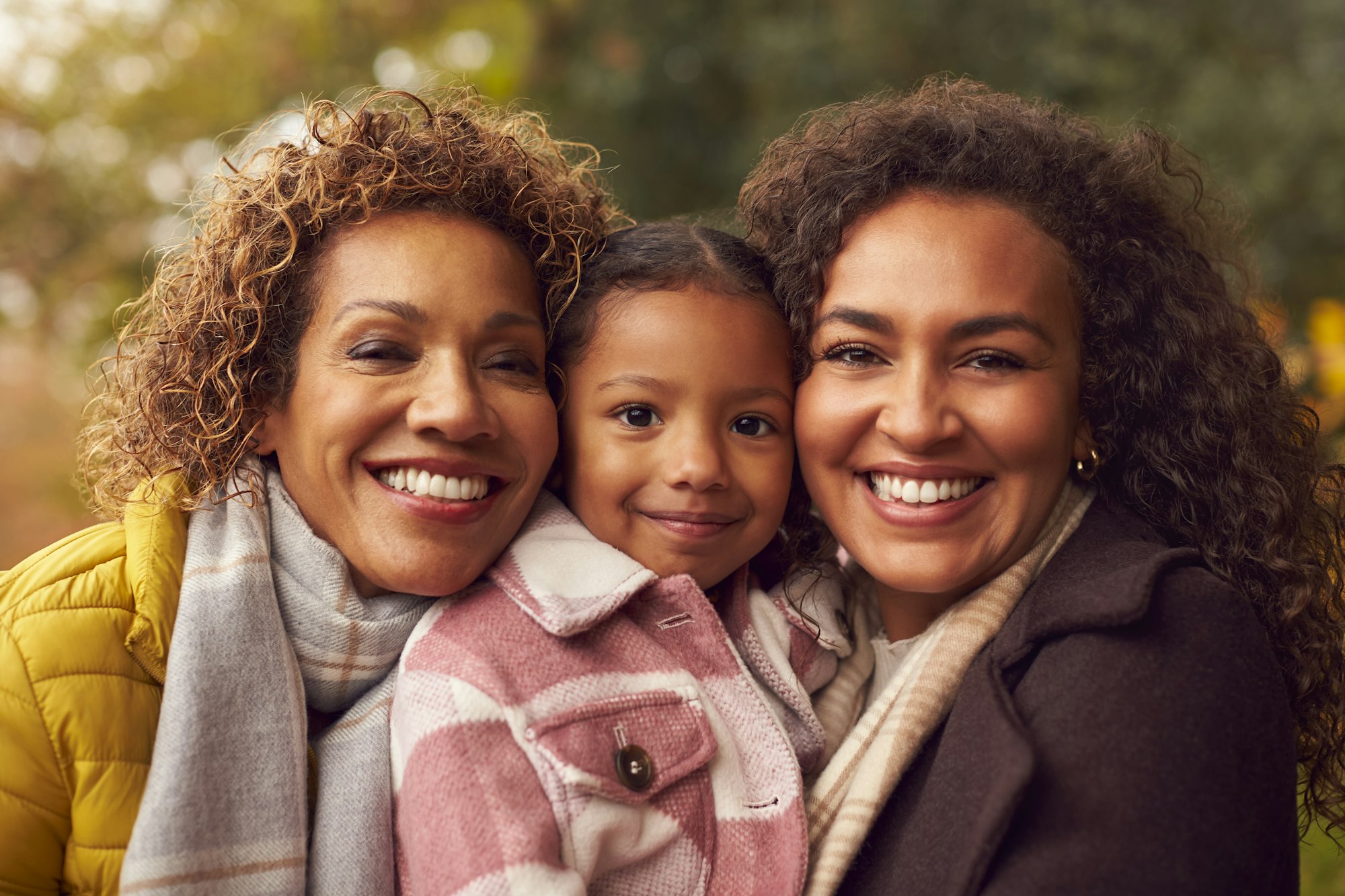 Portrait Of Multi-Generation Female Family On Walk Through Autumn Countryside Together