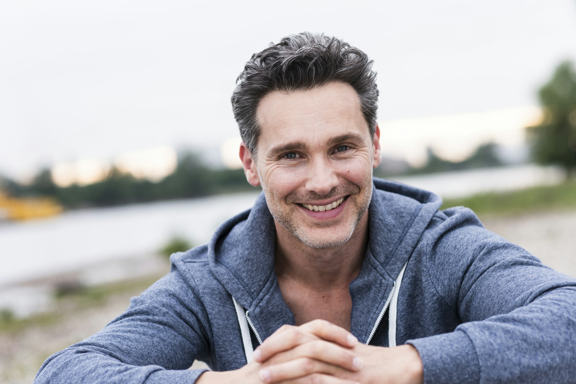 Portrait of smiling man at the riverside