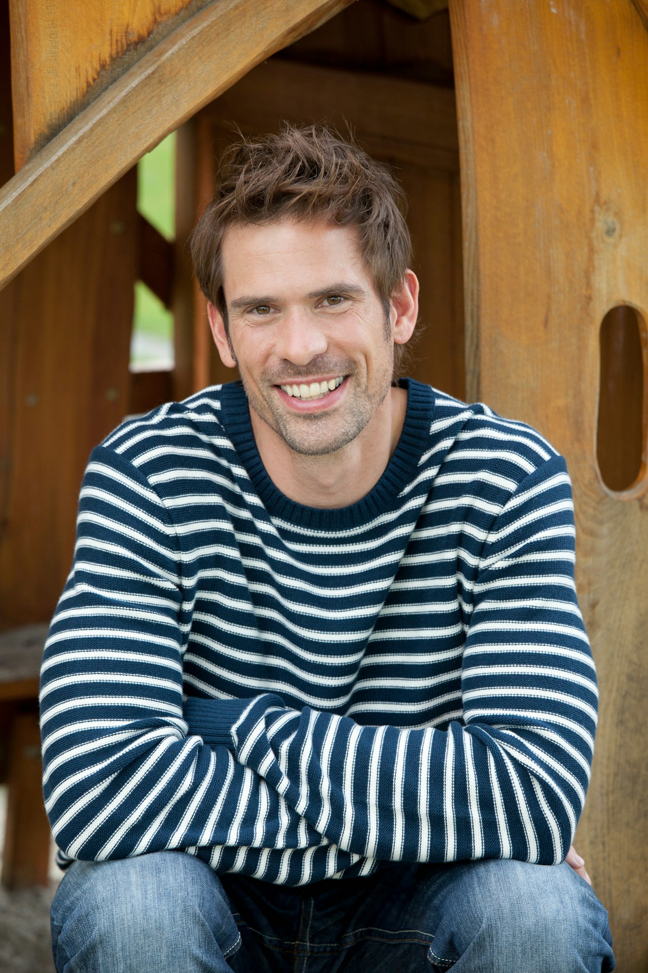 Smiling man sitting outdoors