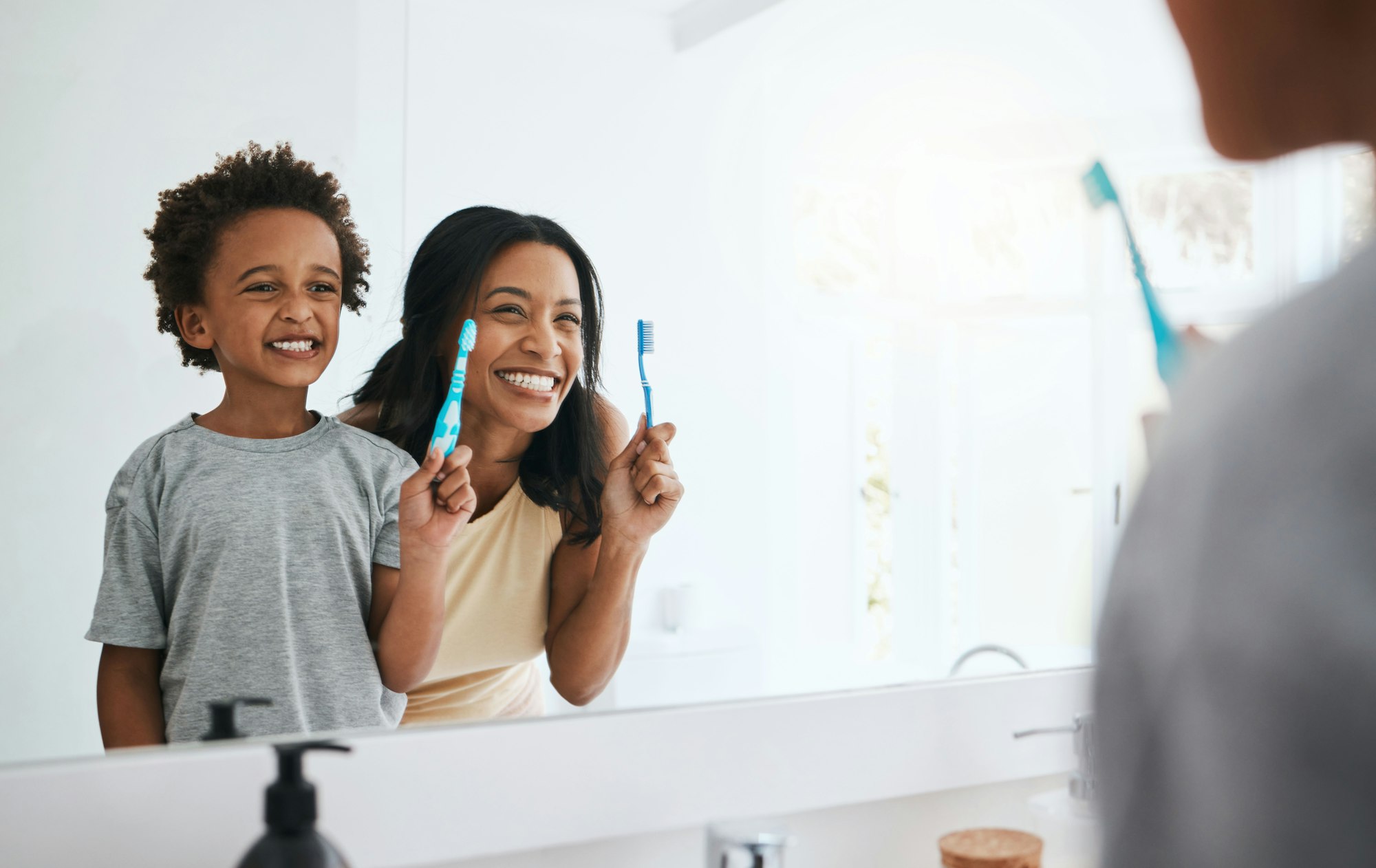 Teaching, mama and son brushing teeth, wellness and cleaning mouth at home, bathroom and smile. Fam